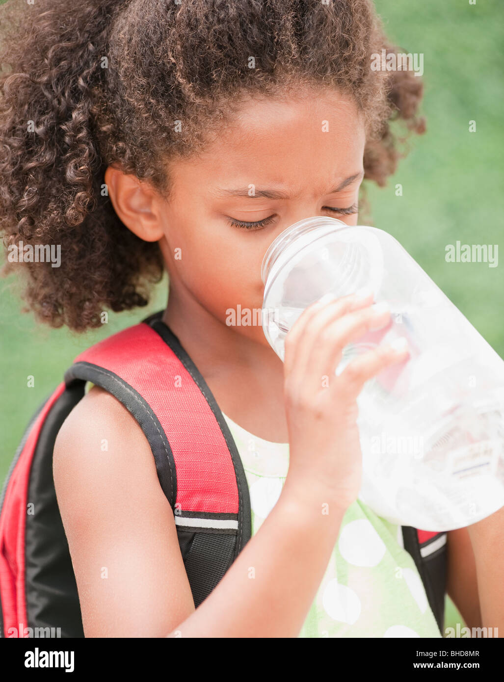 Mixed race girl drinking water Stock Photo