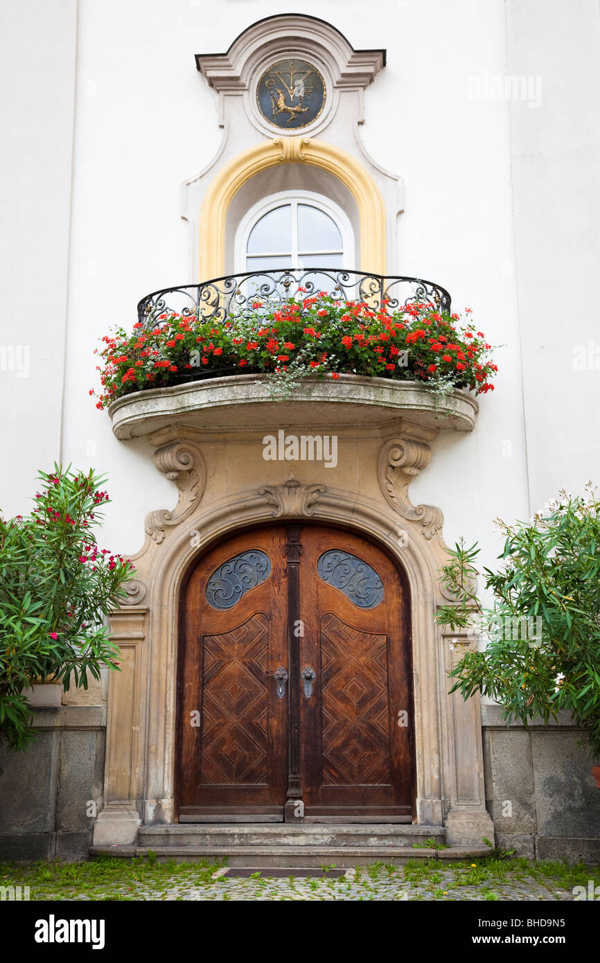 Carved wooden door and balcony with flowers at Dom St Stephan, Passau, Bavaria, Germany, Europe Stock Photo