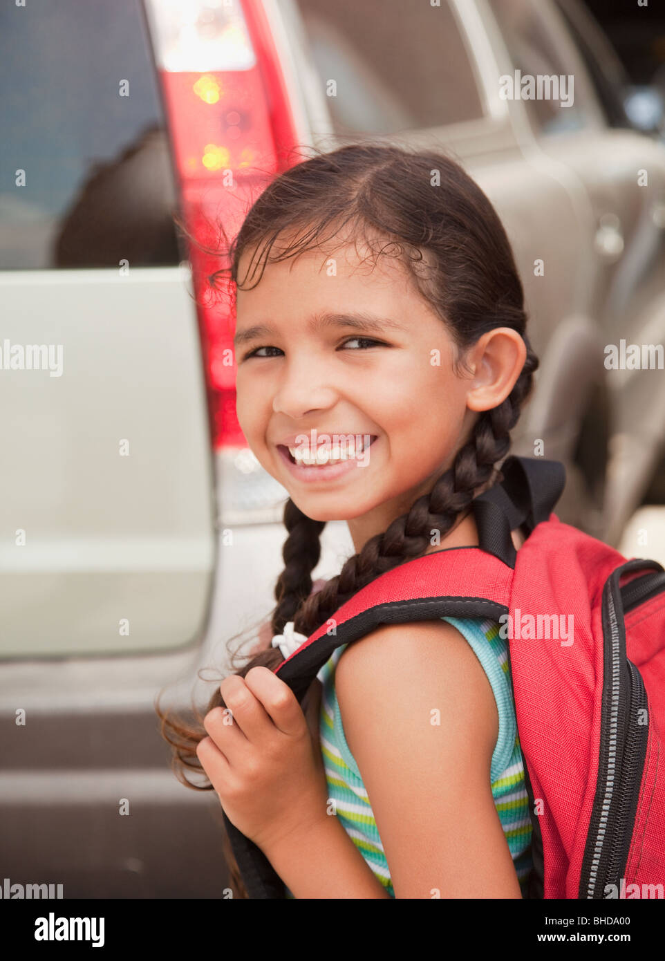 Smiling Hispanic girl carrying backpack Stock Photo - Alamy