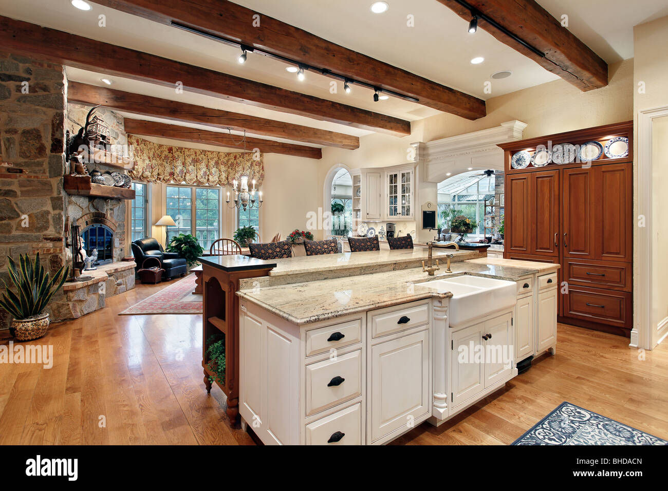 Kitchen in luxury home with stone fireplace Stock Photo Alamy