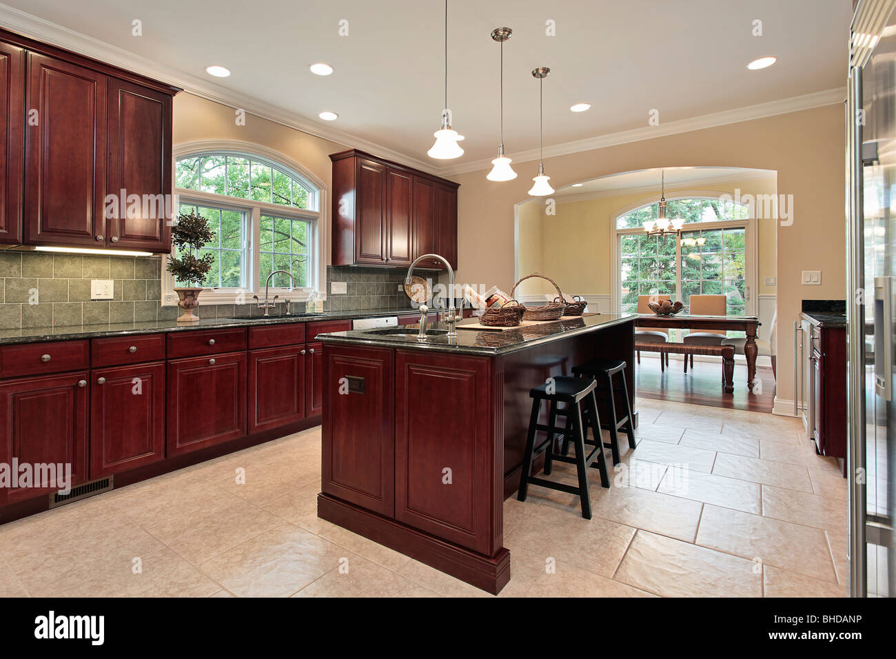 Kitchen In Luxury Home With Cherry Wood Cabinetry Stock Photo Alamy