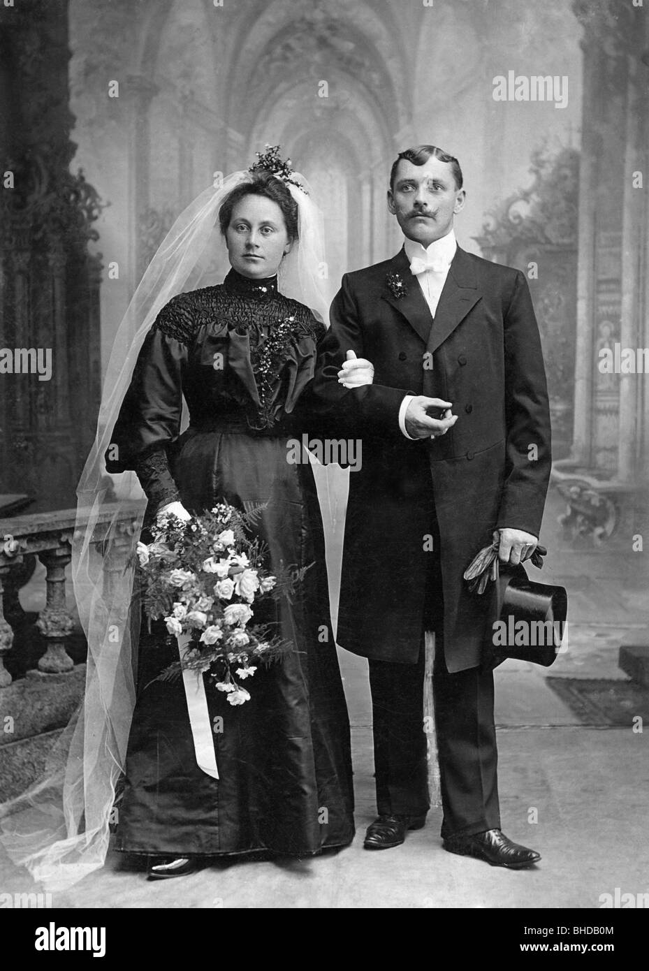 people, couples, 1900 - 1930, wedding picture by A. Eberwein, Neu-Ulm, Germany, circa 1900, Neu - Ulm, top hat, bunch of flowers, bridal couple, historic, historical, wedding, weddings, full length, standing, clothes, outfit, outfits, veil, veils, flowers, flower, frock coat, Germany, German Empire, woman, women, female, man, men, male, people, 20th century, nostalgia, 1900s, Stock Photo