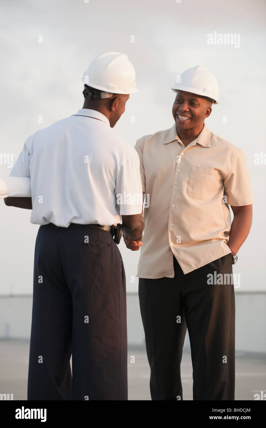 Shaking hands hard hat hires stock photography and images Alamy