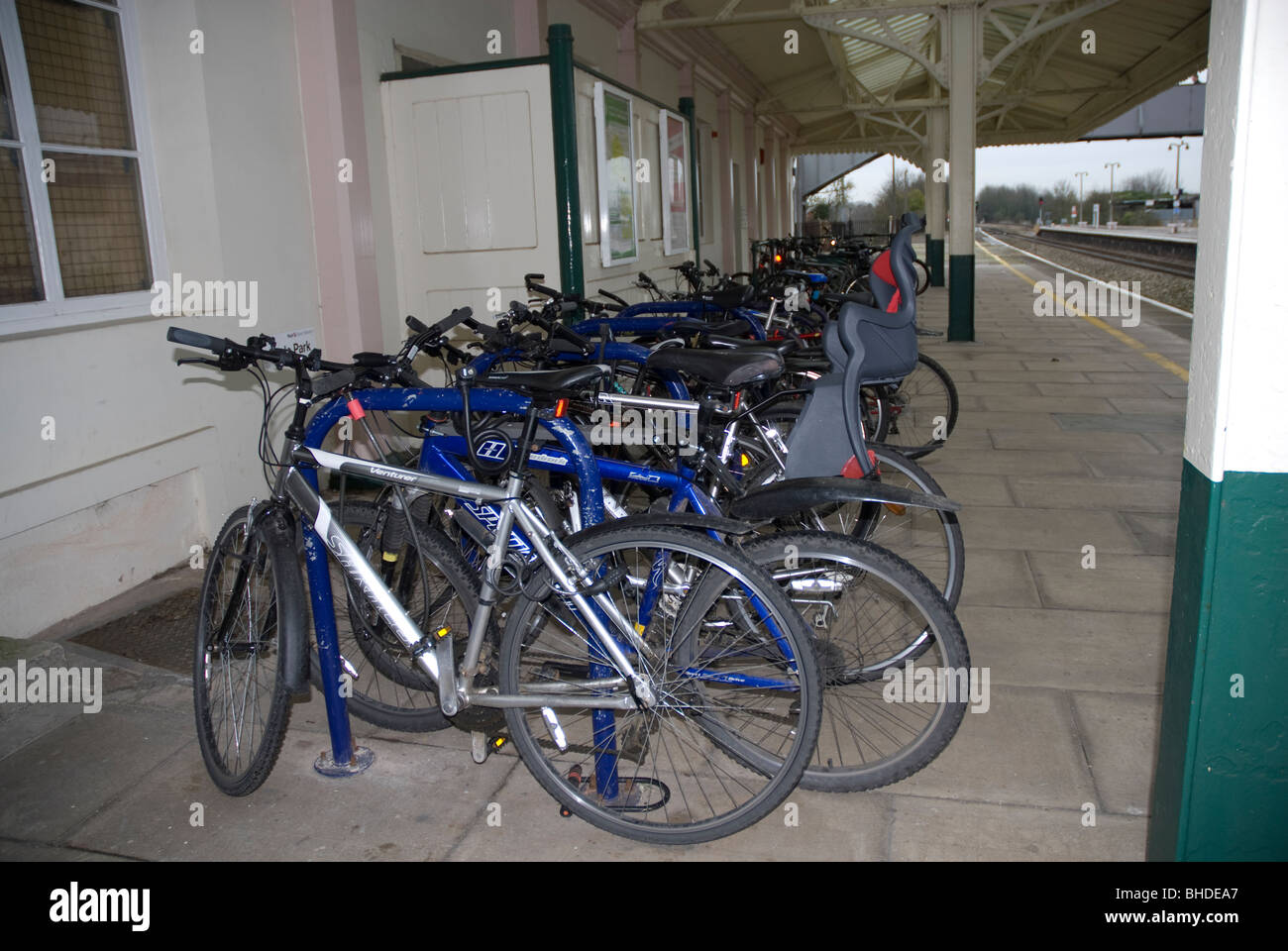 Bicycles chained to a cycle rack on the platform at Chippenham Railway Station wiltshire, UK Stock Photo