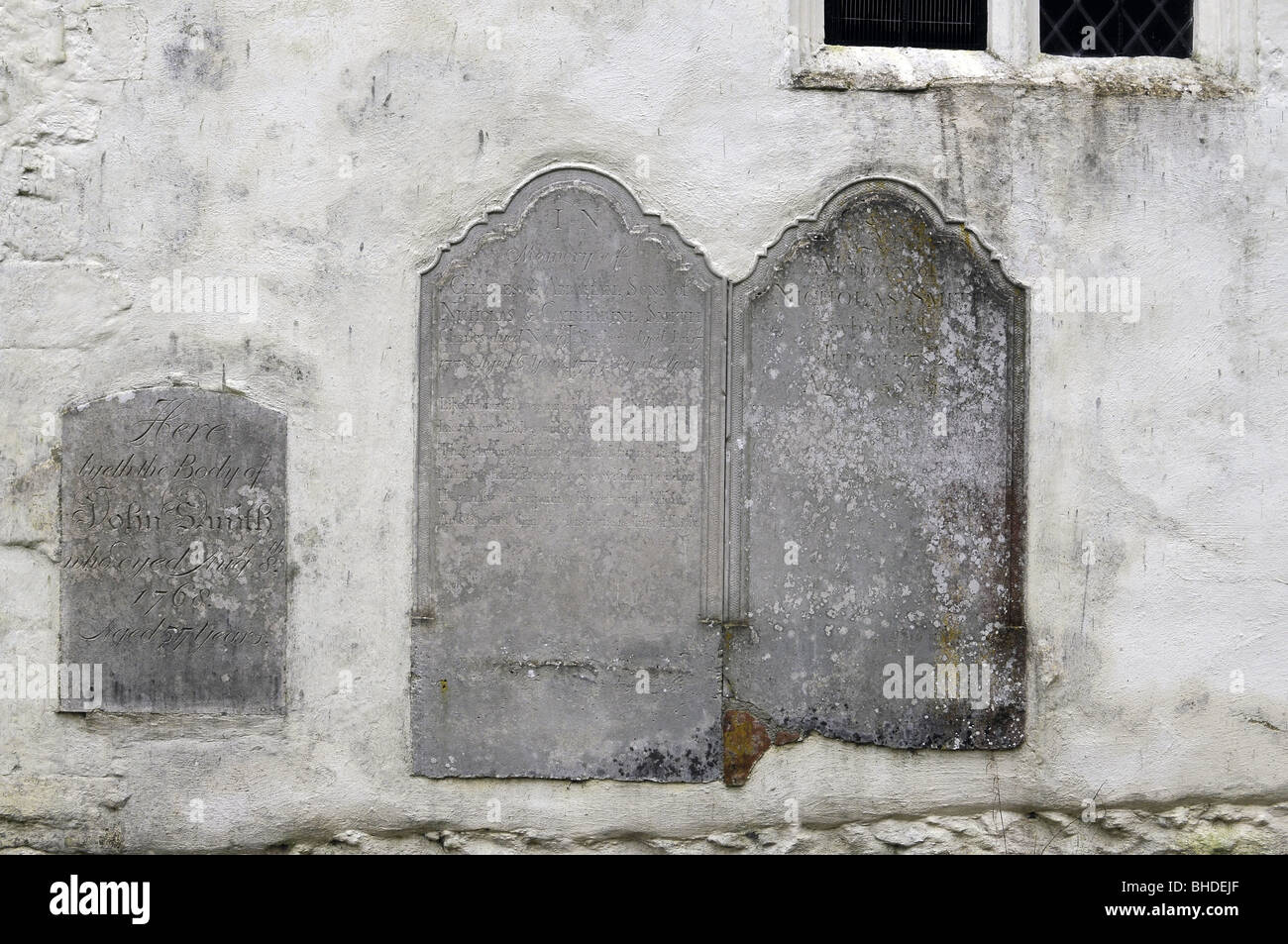 Grave stones built into the exterior of St Marys Church, Ashley, Hampshire, England, UK Stock Photo