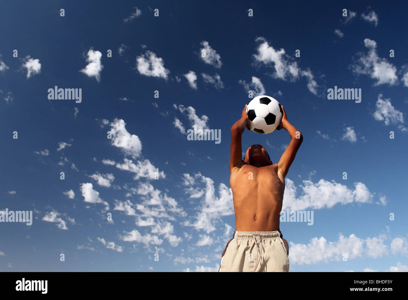 A boy plays with a soccer ball in Ottery, Cape Town, South Africa Stock