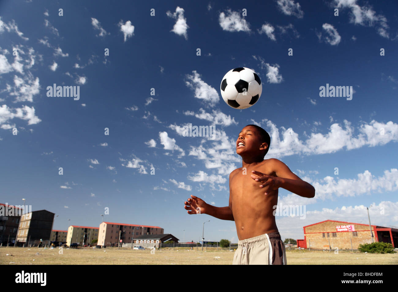 A boy plays with a soccer ball in Ottery, Cape Town, South Africa Stock
