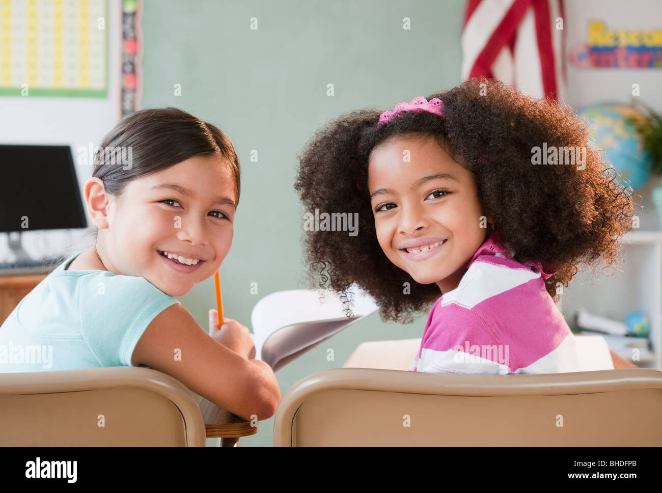 School girls smiling in classroom Stock Photo