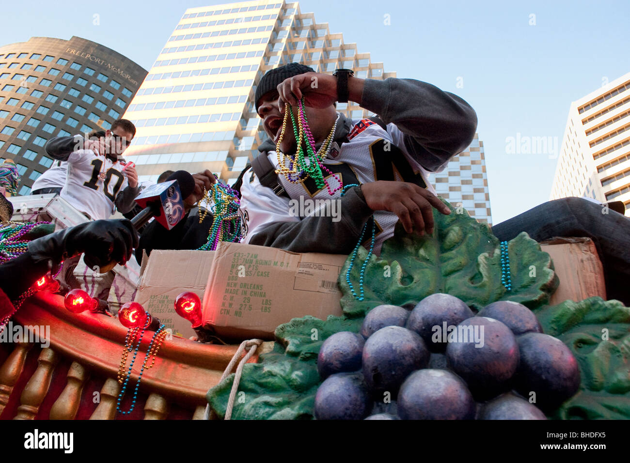 Saints football player throws beads from a float in the Super Bowl Championship parade. New