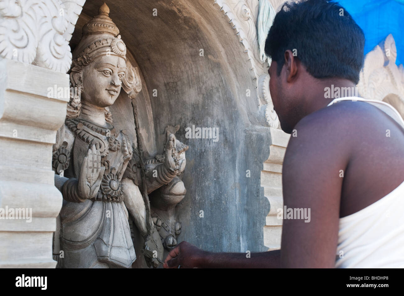 Indian man creating concrete temple deity sculptures on a hindu temple roof. Andhra Pradesh, India Stock Photo