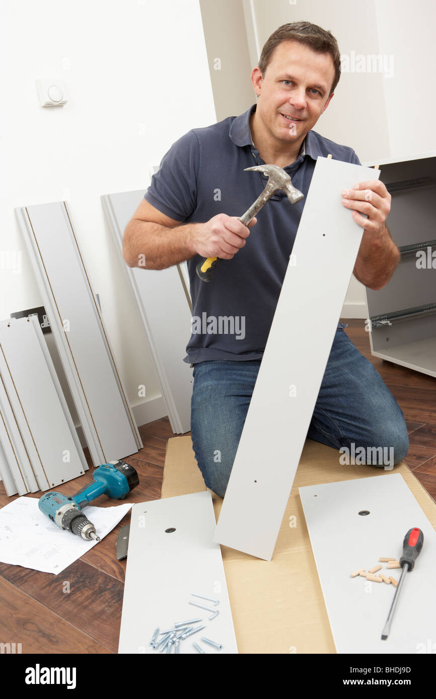 Man Assembling Flat Pack Furniture Stock Photo