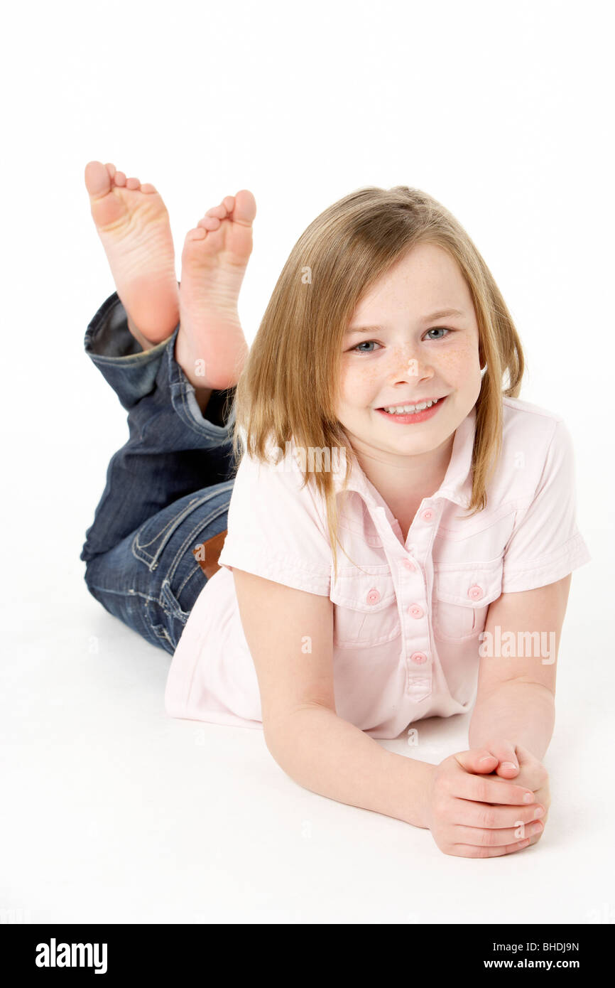 Young Girl Lying On Stomach In Studio Stock Photo