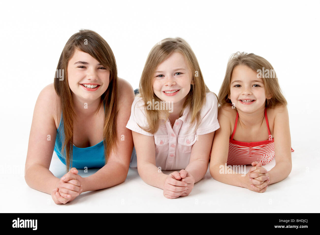 Three Girls Piled Up In Pyramid In Studio Stock Photo