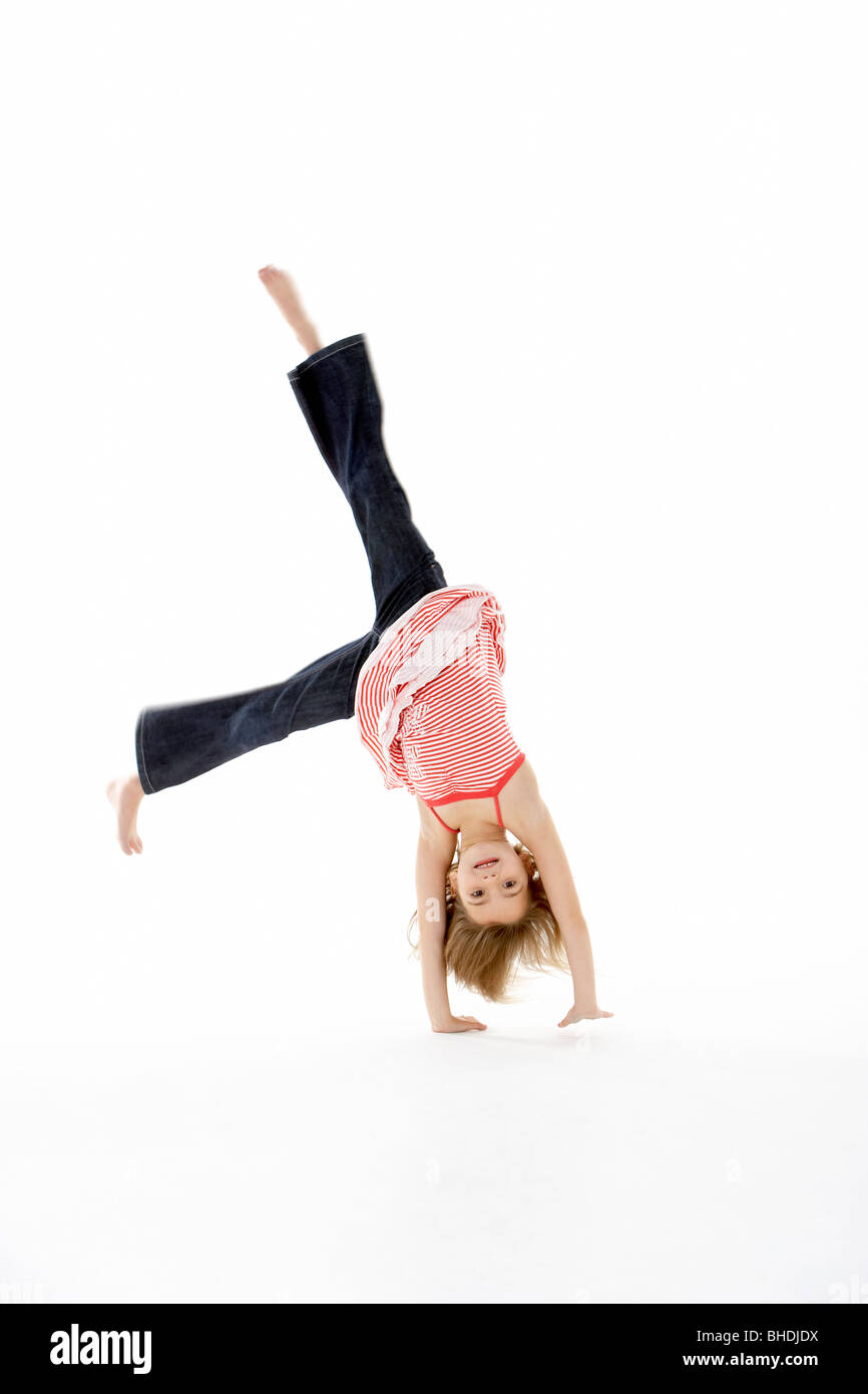 Young Girl In Gymnastic Pose Doing Cartwheel Stock Photo