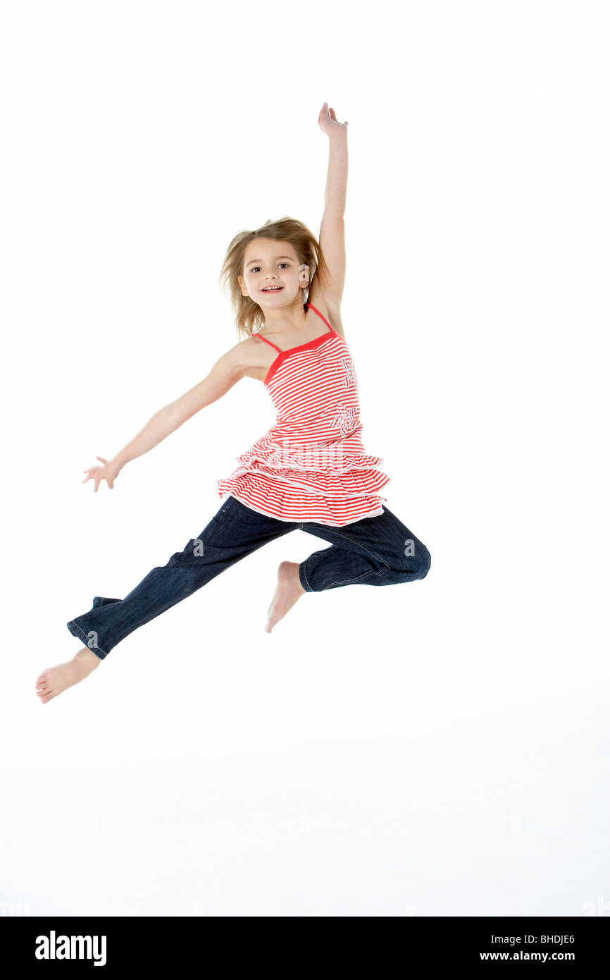 Young Girl Jumping In Mid Air Stock Photo