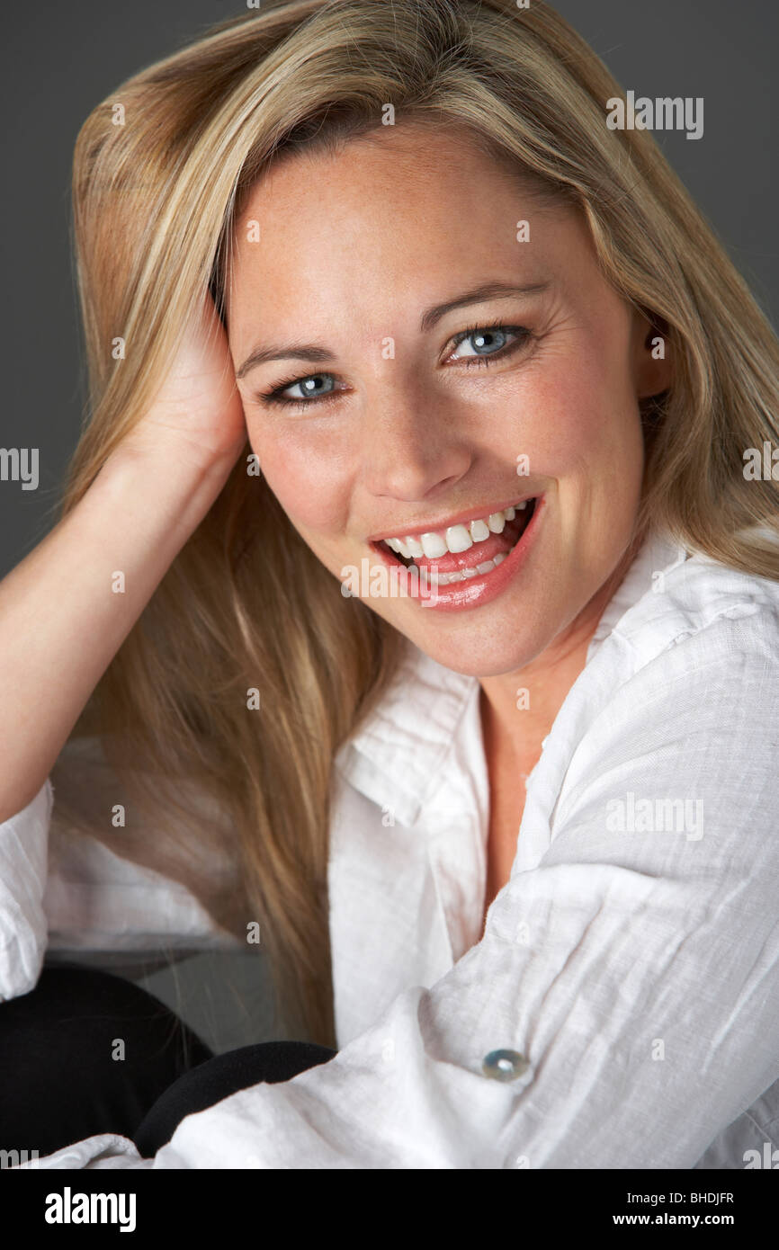 Studio Portrait Of Woman Wearing White Shirt Stock Photo