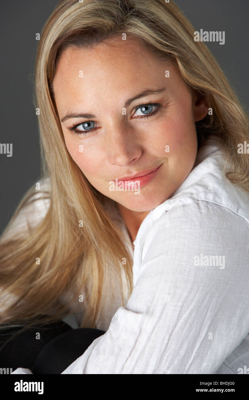 Studio Portrait Of Woman Wearing White Shirt Stock Photo