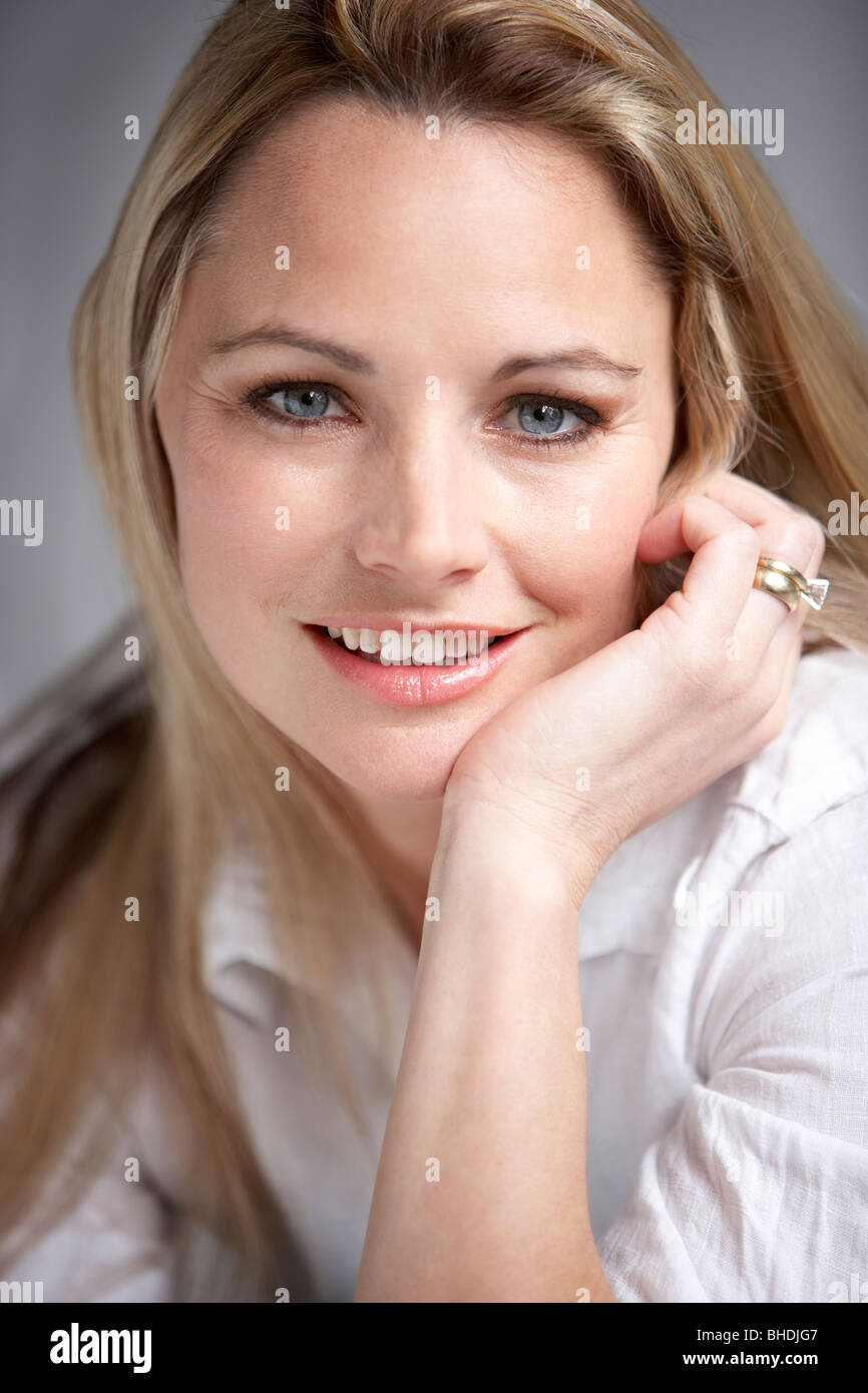 Studio Portrait Of Woman Wearing White Shirt Stock Photo