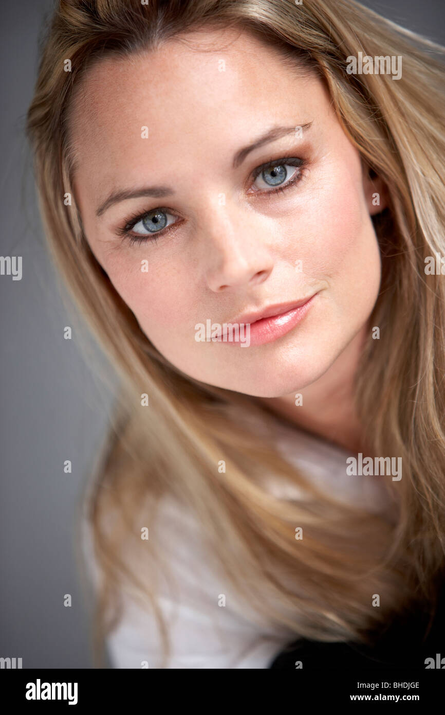 Studio Portrait Of Woman Wearing White Shirt Stock Photo