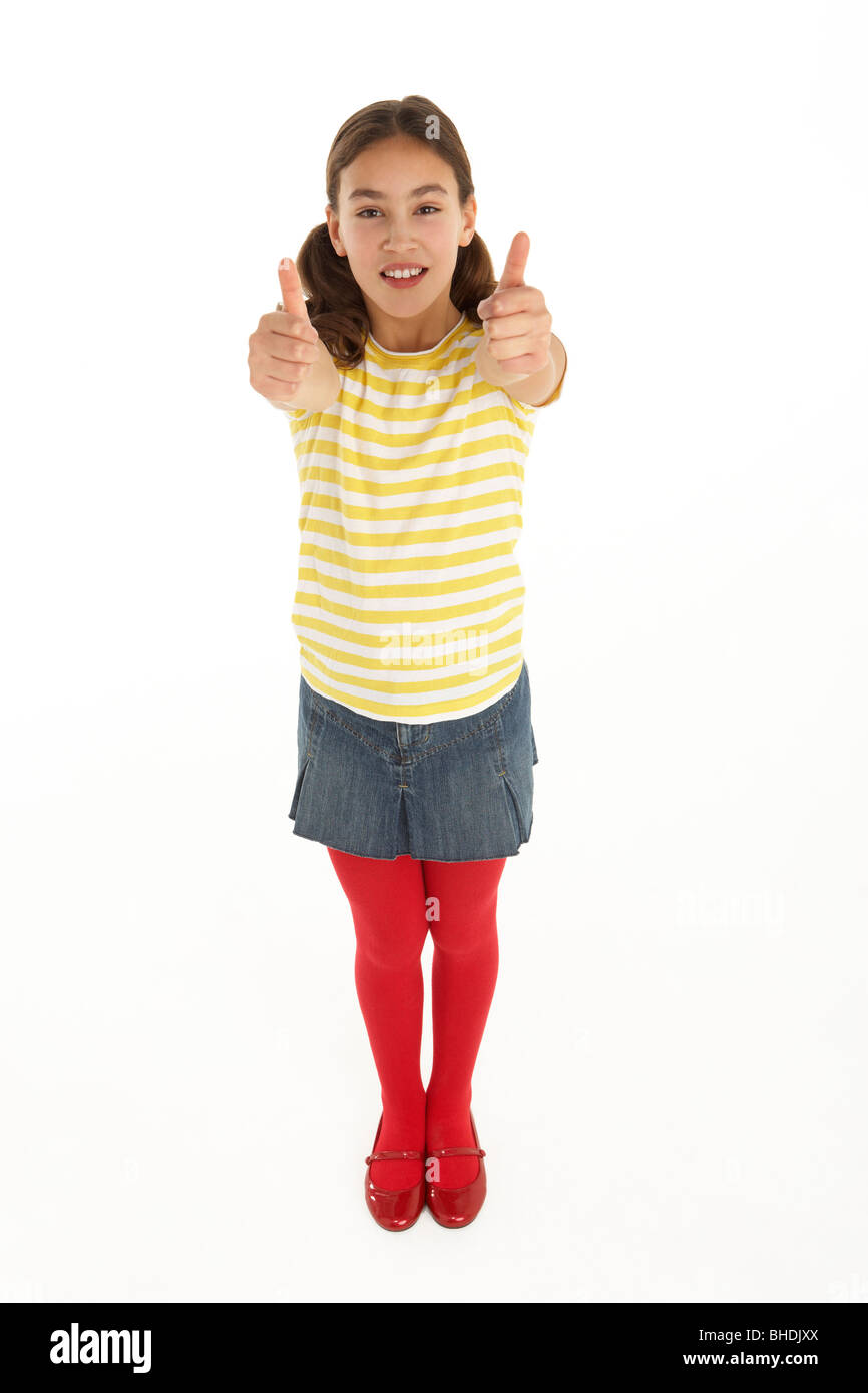 Studio Portrait Of Happy young Girl Giving Thumbs Up Gesture Stock Photo
