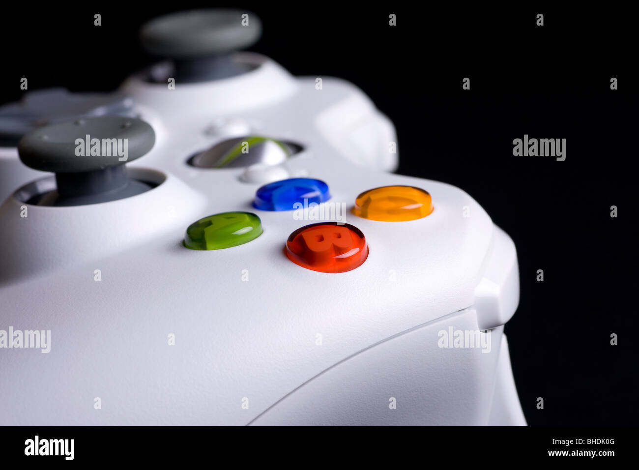Xbox 360 controller main XYAB button on a black background Stock Photo