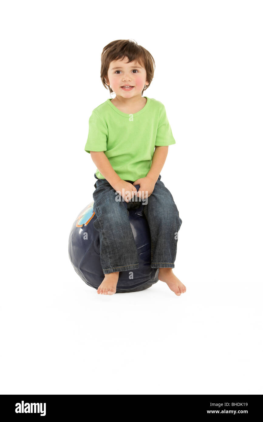 Young Boy Having Fun On Inflatable Hopper Stock Photo