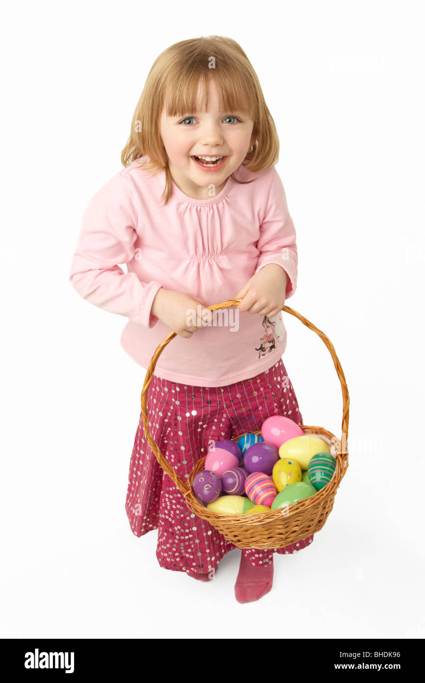 Young Girl Carrying Basket Filled With Easter Eggs Stock Photo