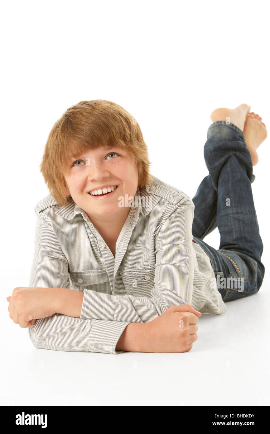 Young Boy Lying On Stomach In Studio Stock Photo
