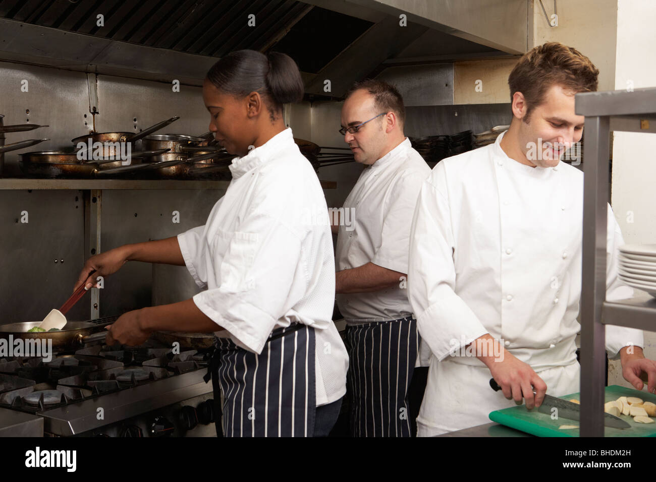Team Of Chefs Preparing Food In Restaurant Kitchen Stock Photo Alamy