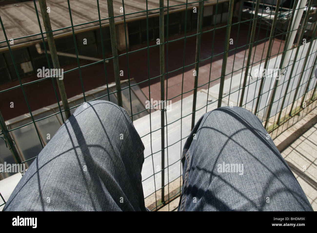 person sitting on terrace in inner city urban scene Stock Photo