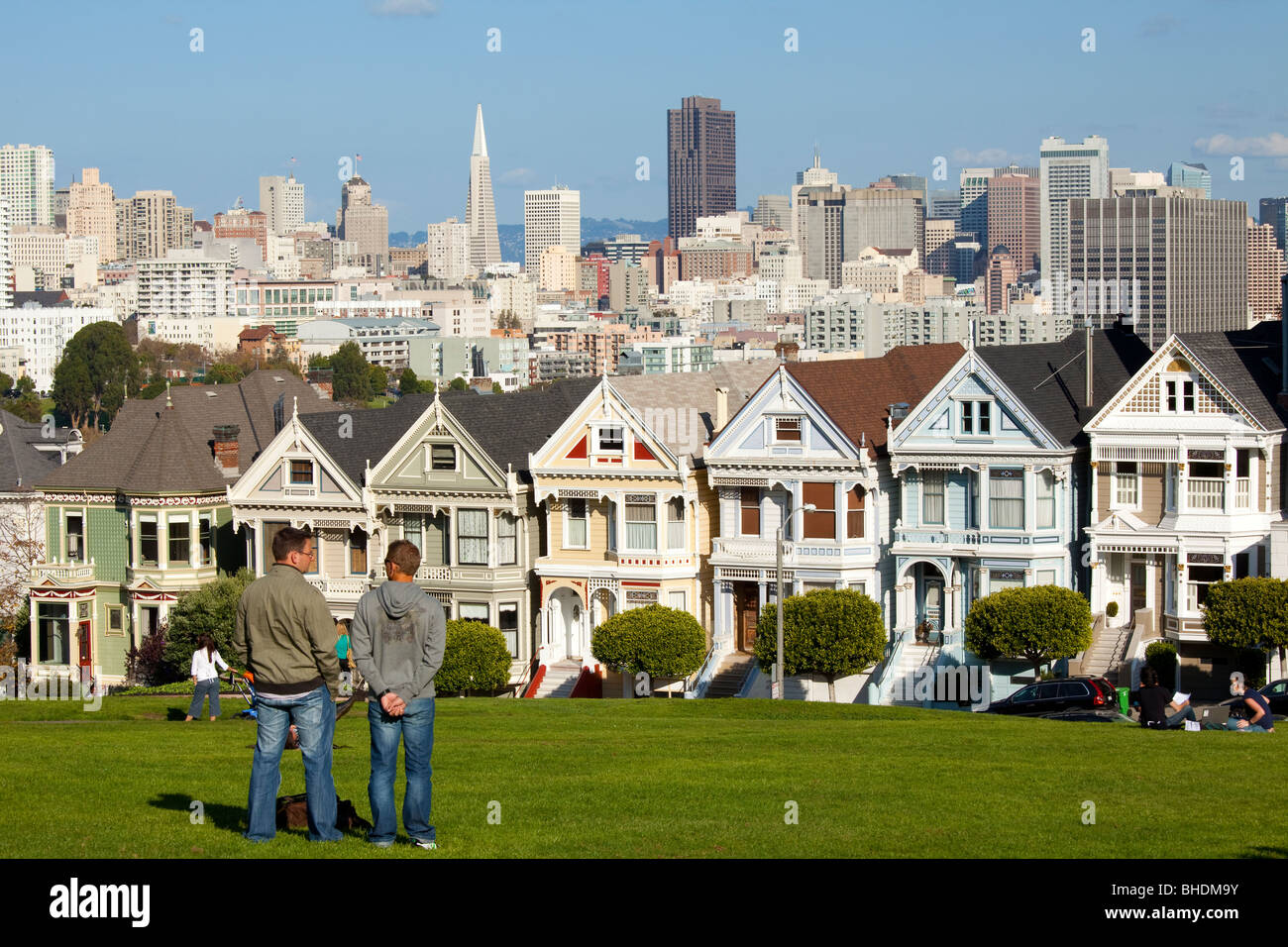 Famous victorian houses and skyline viewed from alamo square stock