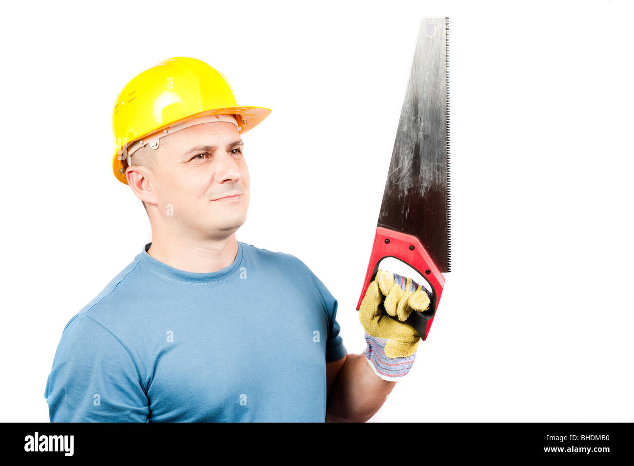 Blue collar worker with yellow helmet and handsaw, isolated on white background Stock Photo
