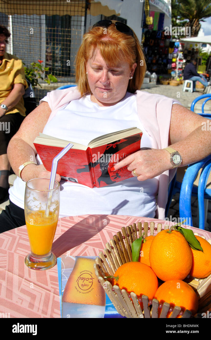 Woman reading book in cafe, Port El Kantaoui Marina, Port El Kantaoui, Sousse Governorate, Tunisia Stock Photo