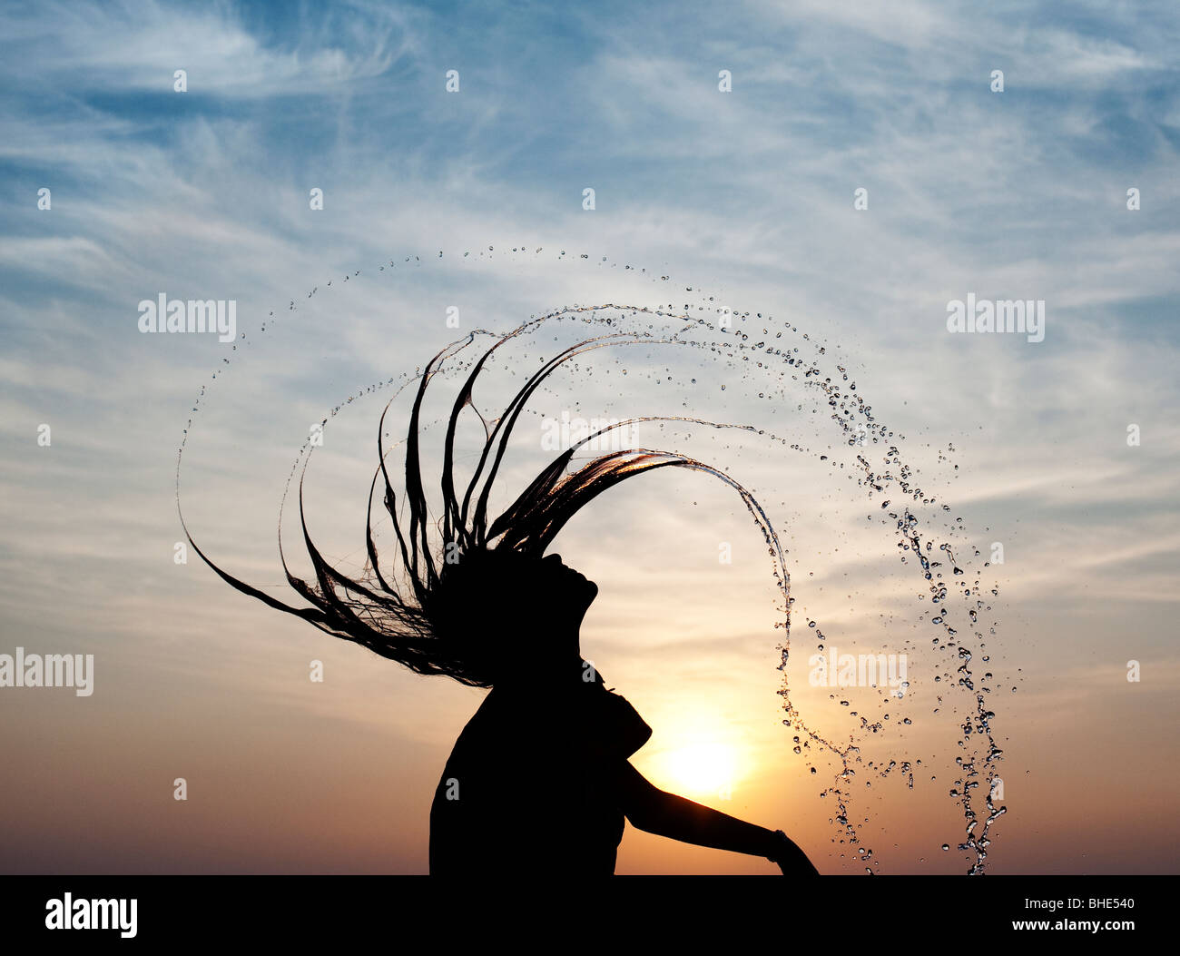Indian girl throwing her wet hair back causing water spray silhouette. India Stock Photo - Alamy Indian girl throwing her wet hair back causing water spray silhouette. India Stock Photo - Alamy