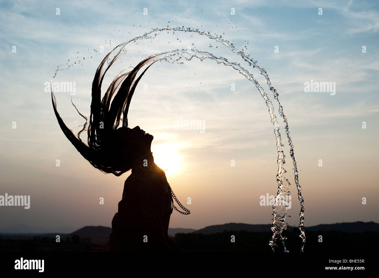 Indian girl throwing her wet hair back causing water spray silhouette. India Stock Photo - Alamy Indian girl throwing her wet hair back causing water spray silhouette. India Stock Photo - Alamy