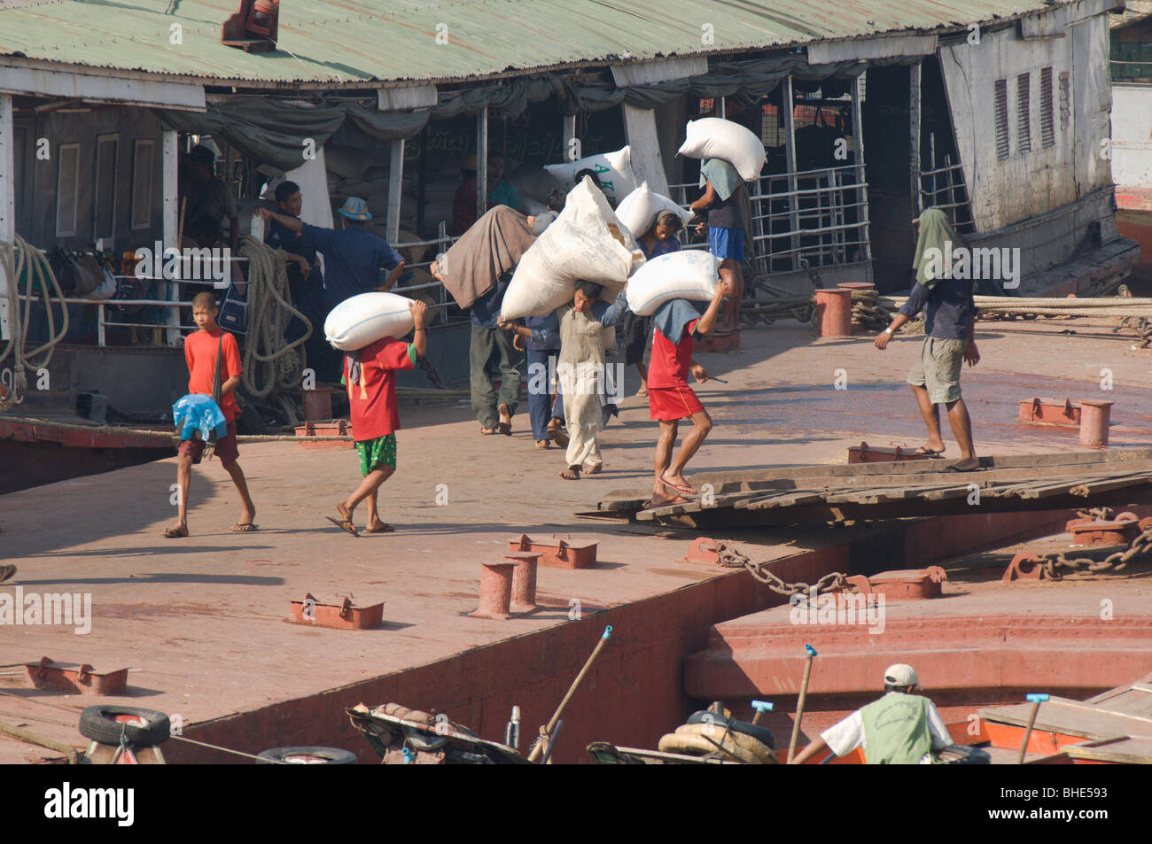 Dockers carrying bags, Rangoon –Yangon riverbank, Burma – Myanmar Stock Photo