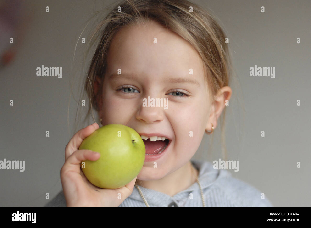 Ella enjoys an apple Stock Photo