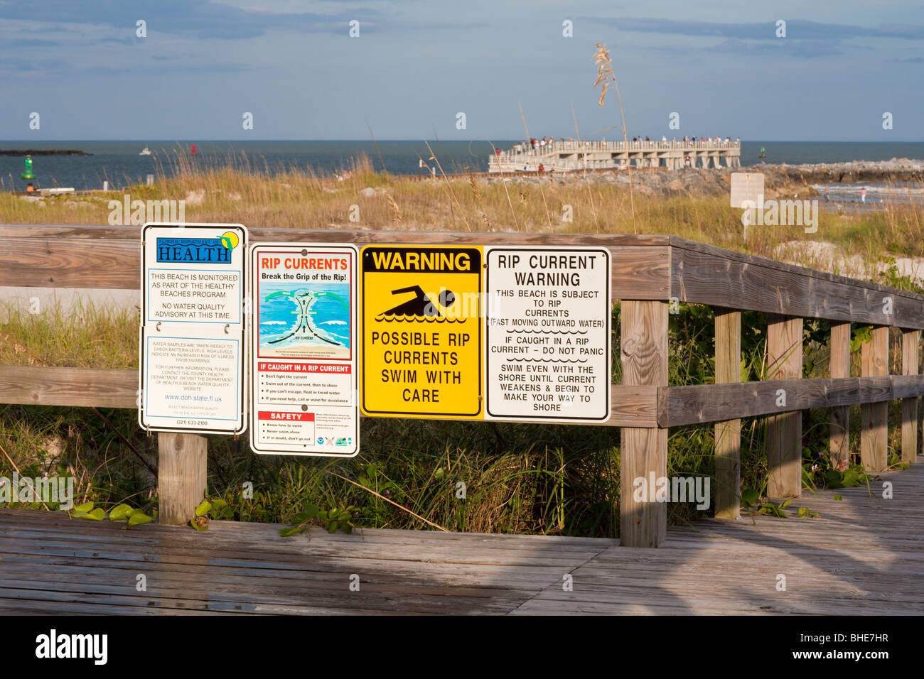 Signs warn beach visitors of water quality advisories and rip currents in the Atlantic Ocean Stock Photo