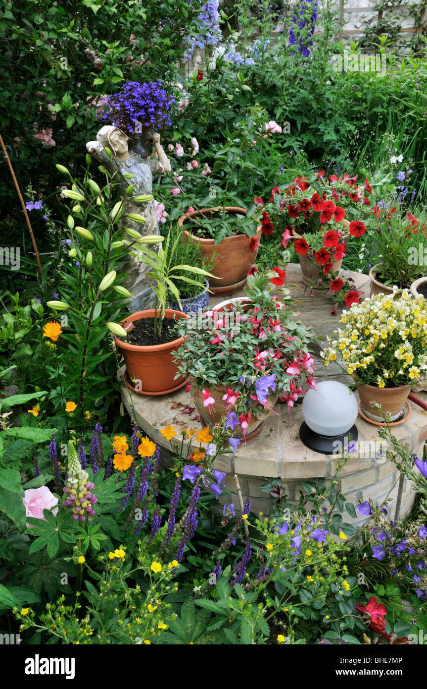 Lobelias (Lobelia), fuchsias (Fuchsia), Nemesia and petunias (Petunia) in a backyard garden. Design: Jutta Wahren Stock Photo