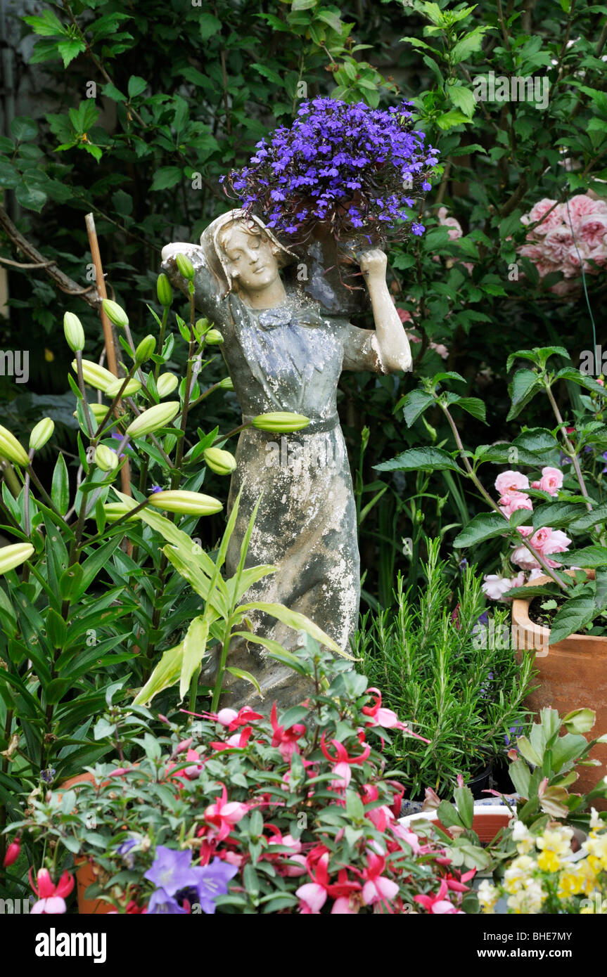 Lobelia (Lobelia) with female figure. Design: Jutta Wahren Stock Photo