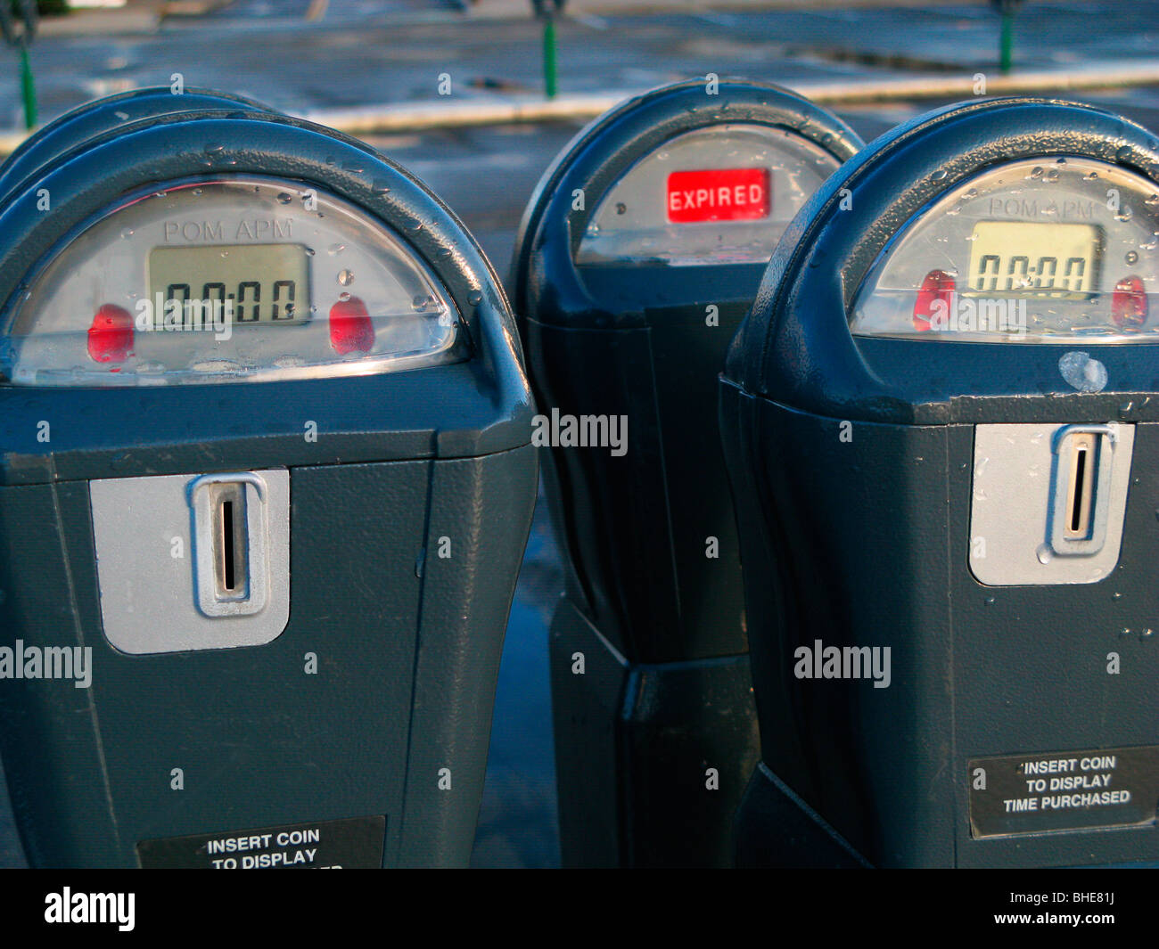 expired parking meters in empty parking lot Stock Photo Alamy