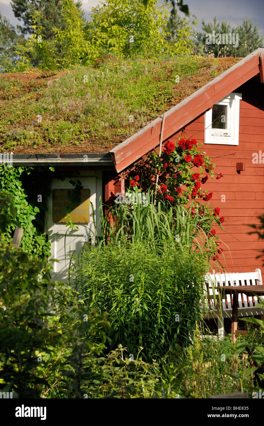 Garden house with green roof in a natural garden Stock Photo