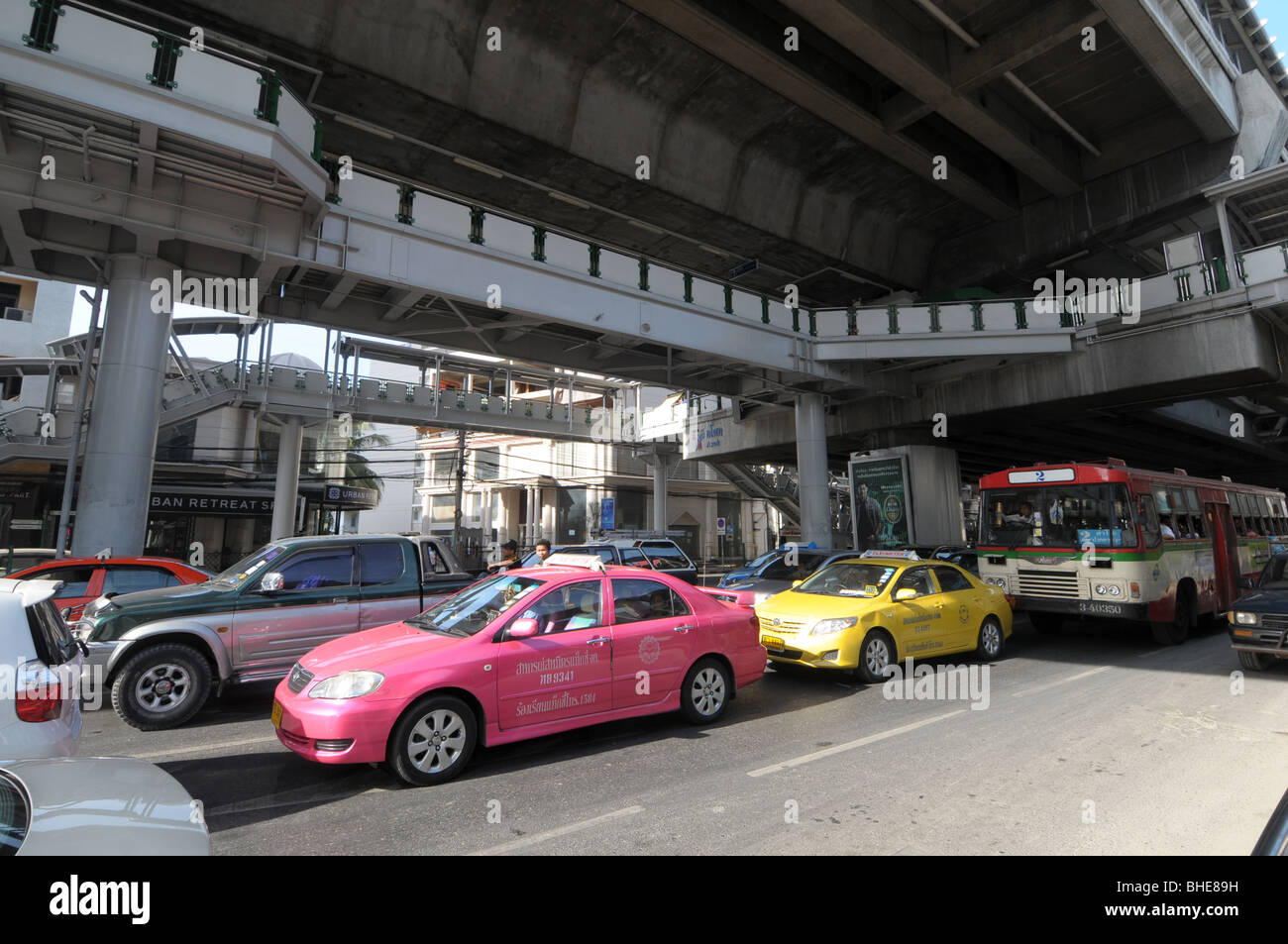 Traffic crawls along Sukhumvit Road below skytrain station Nana Bangkok Thailand. Stock Photo