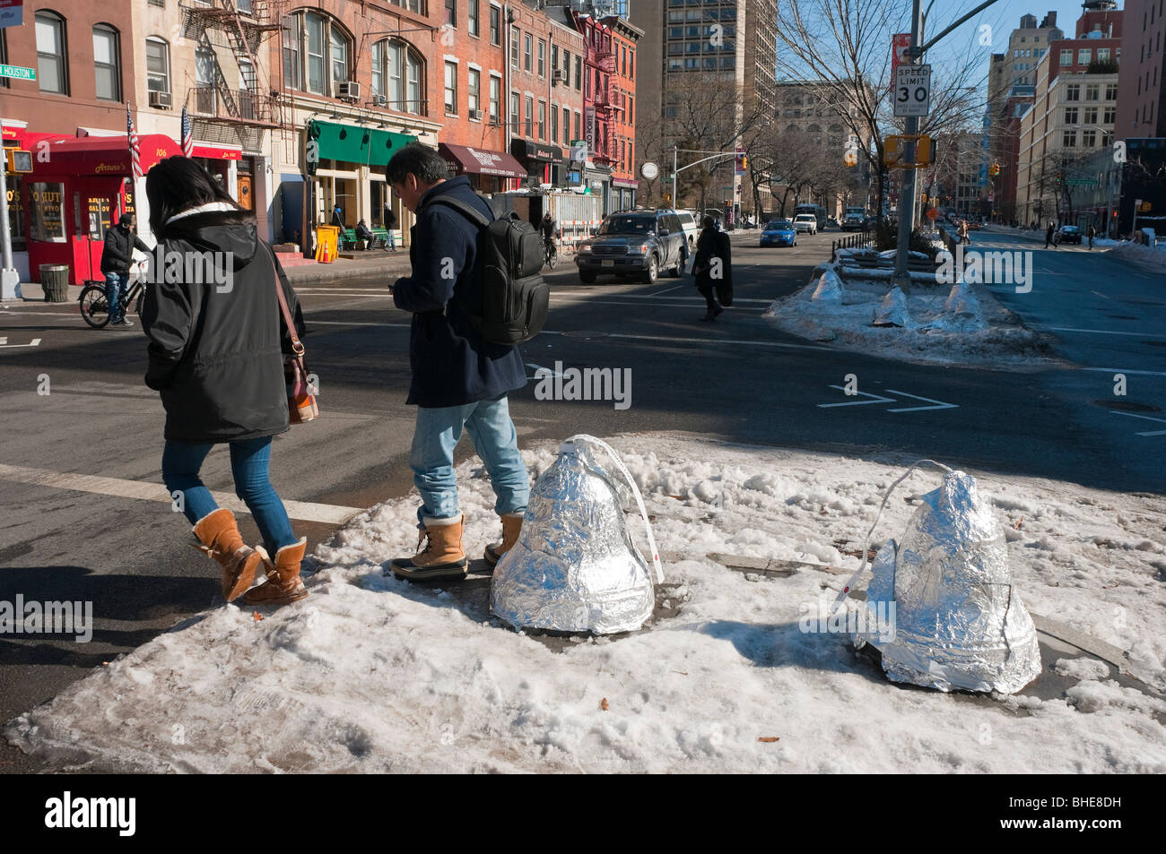 Traffic bollards wrapped in tin foil to resemble Hershey's Kisses mark Valentine's Day  on Houston Street. Stock Photo