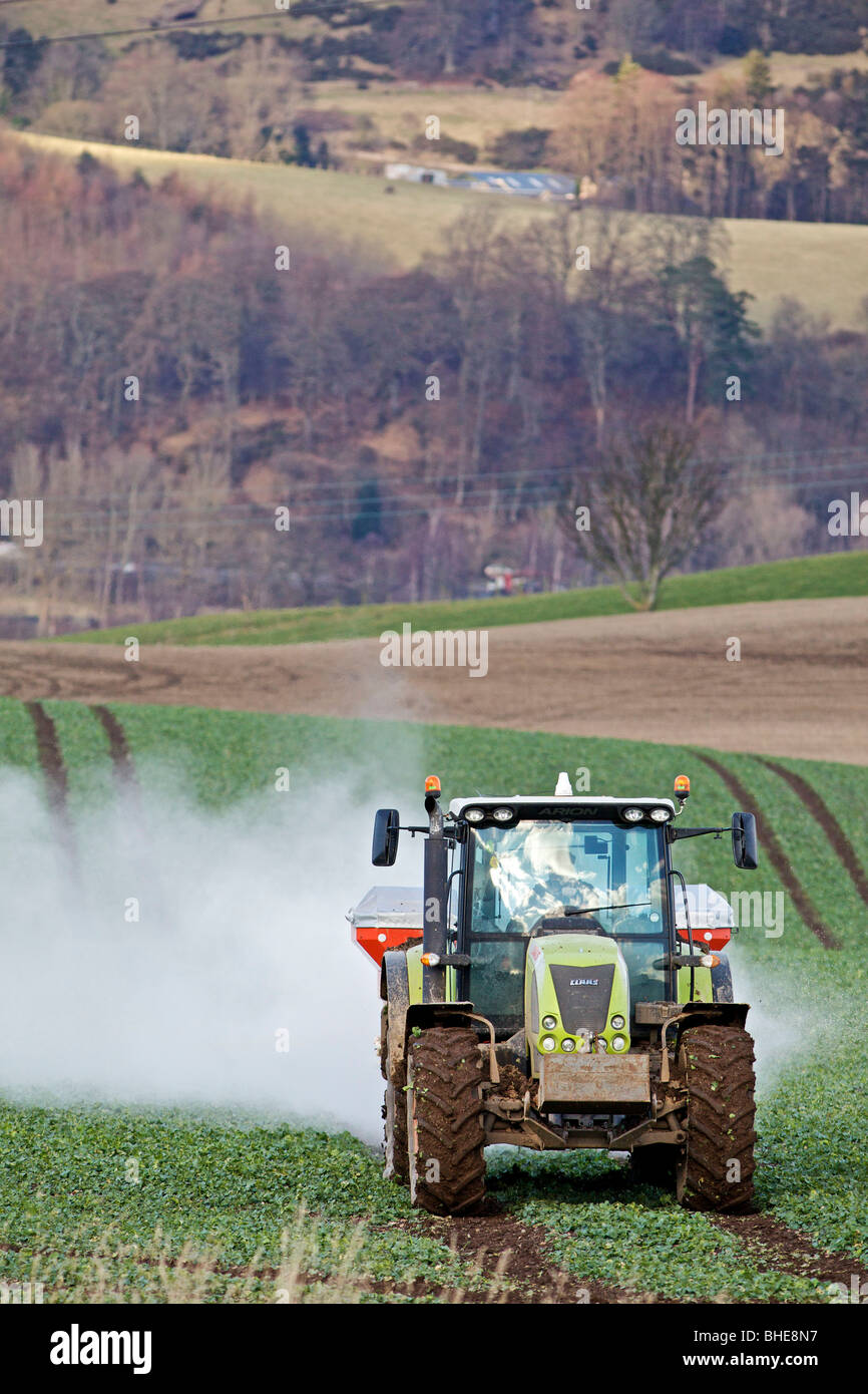 Tractor spraying fertilizer on field in the wind Stock Photo Alamy