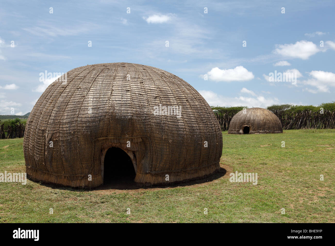 Traditional Zulu huts stand near the town of Ulundi in South Africa's Kwazulu Natal province Stock Photo