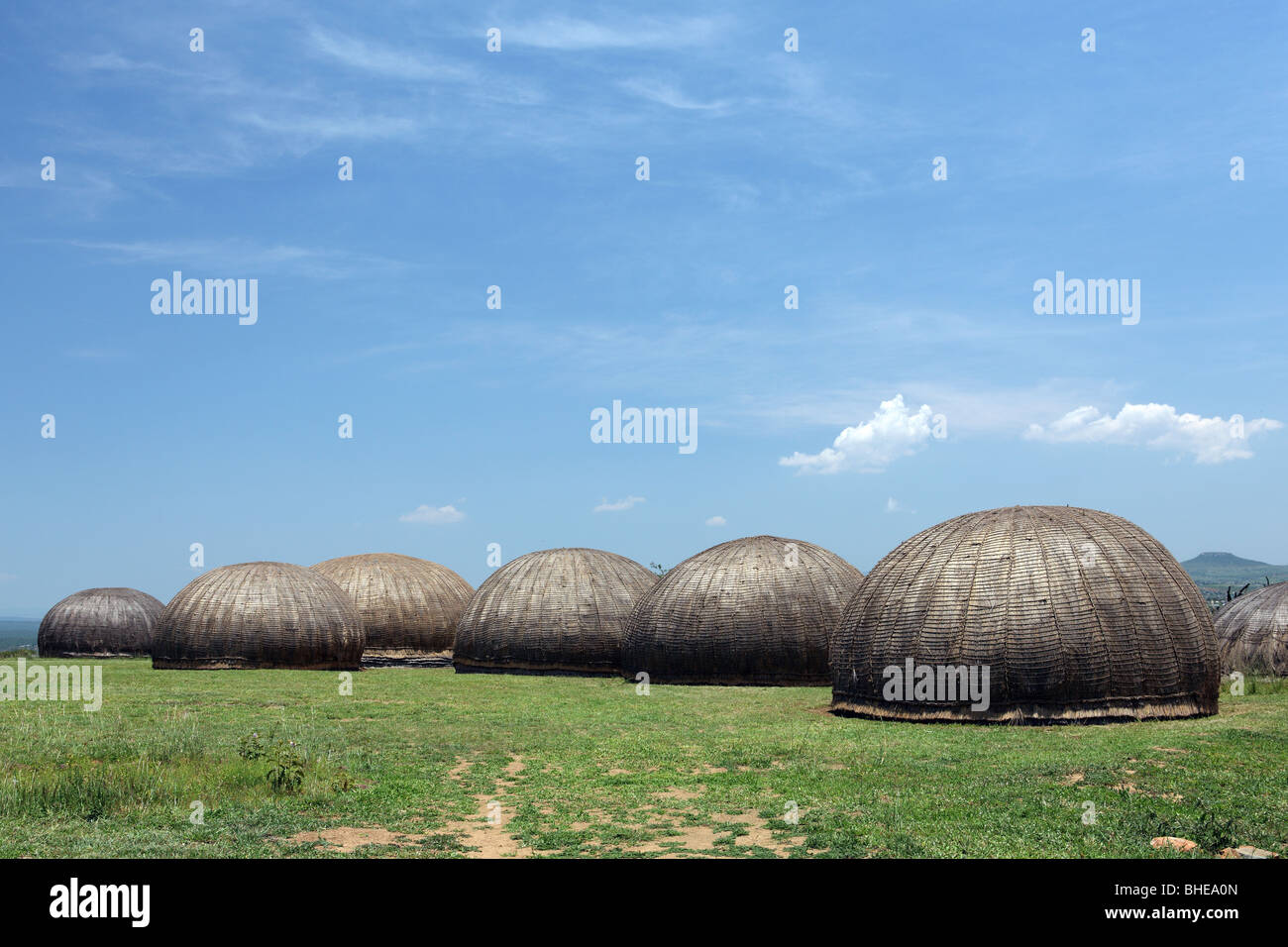 Traditional Zulu huts stand near the town of Ulundi in South Africa's Kwazulu Natal province Stock Photo