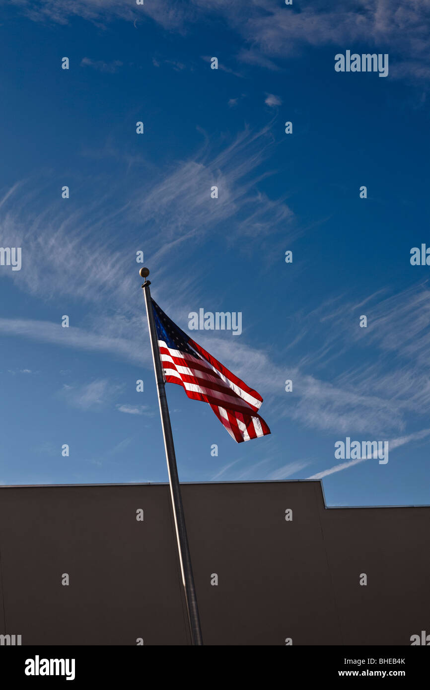 American flag flying over a building in america Stock Photo - Alamy