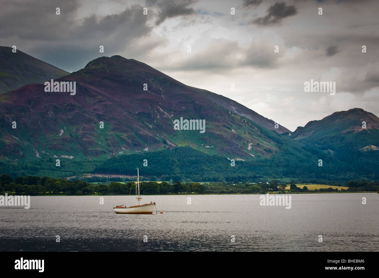 View of single moored on Bassenthwaite Lake, Cumbria, with Ullock Pike and Skiddaw in background. Stock Photo