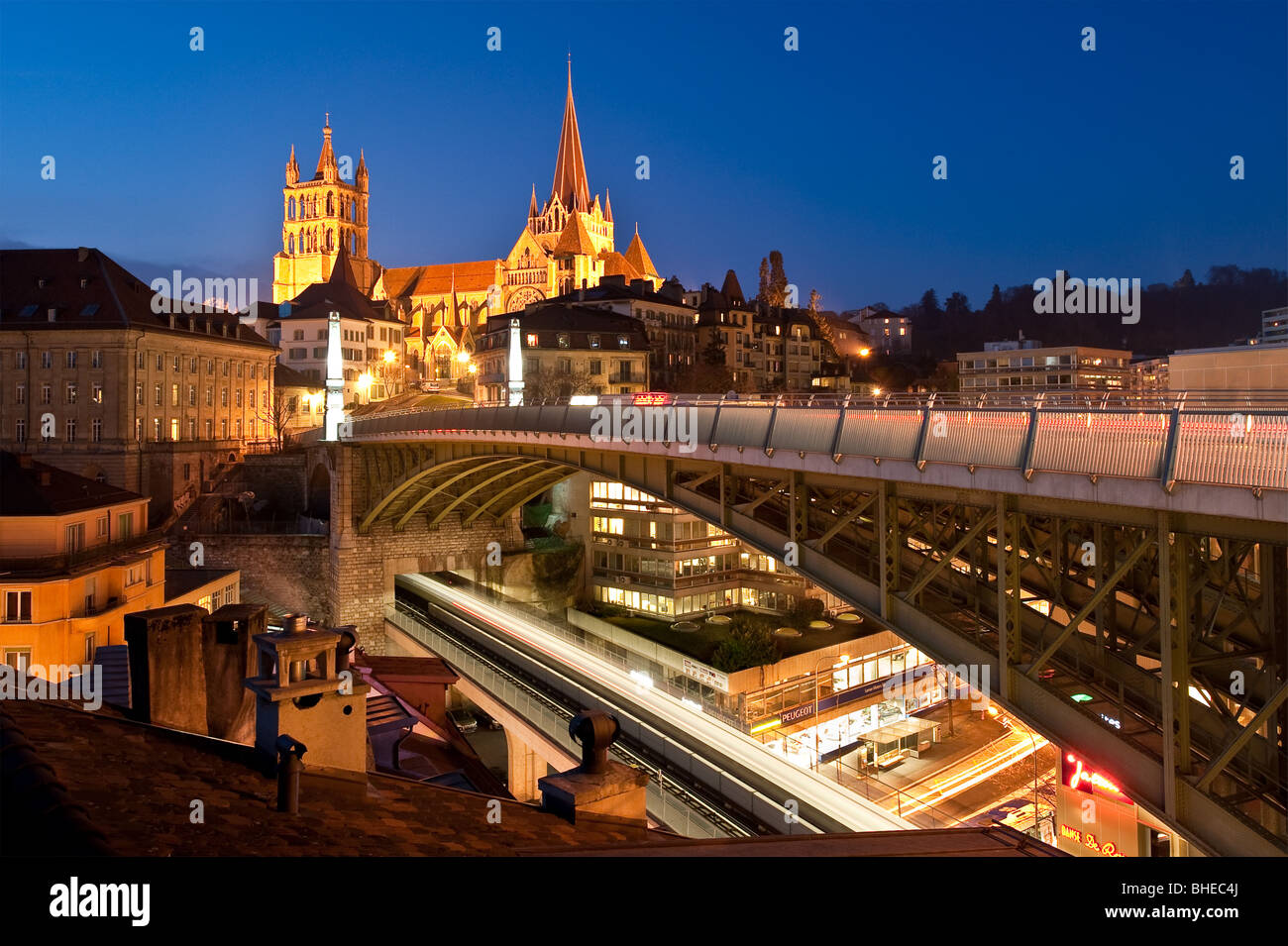 Night view of the Cathedral of Lausanne, Switzerland with the bridge of Bessieres and the new subway Stock Photo